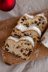 Homemade Christmas Stollen Bread on a rustic wooden board, top view. Close-up.