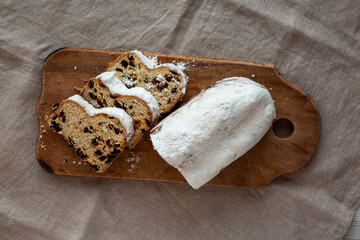 Homemade Christmas Stollen Bread on a rustic wooden board, top view. Flat lay, overhead, from above.