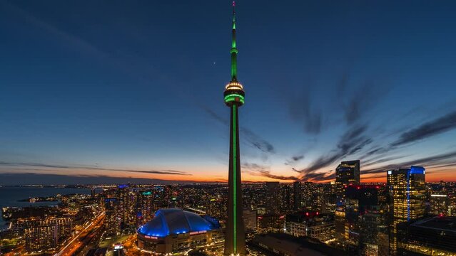 Day to night zoom in timelapse view of Toronto cityscape showing Downtown buildings and landmarks, Toronto, Ontario, Canada.