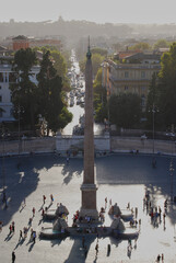 The late afternoon sun casts long shadows in Piazza del Popolo, Rome, Italy.