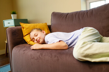 little cute girl sleeping on sofa after study in school daytime