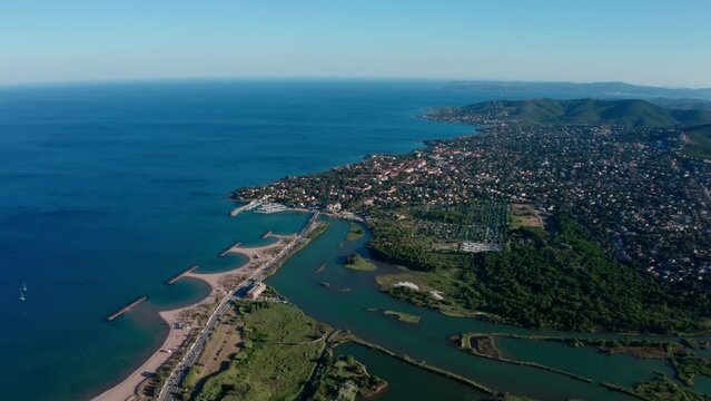 River l'Argens joining the mediterranean sea Saint Aygulf city in background sunny day aerial