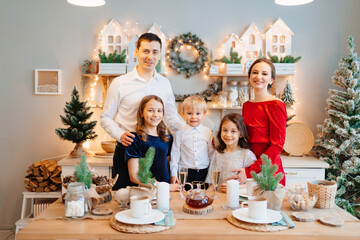 Beautiful big family in the kitchen with Christmas decor. to cook together.