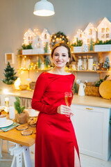 a woman in a red dress with a glass of champagne in a room with garlands.