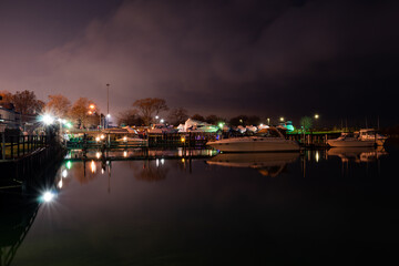 Naklejka na ściany i meble Marina at night with boats and colorful lights.