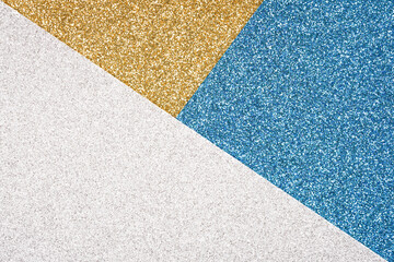 Abstract geometric composition in golden, blue and silver colours with copy space. Minimal fashionable style backdrop. Luxury background. Festive glitter background