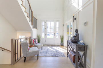 Wide angle shot of the entrance door entry way foyer from inside looking out. Bright foyer with...