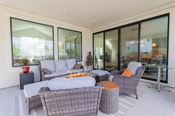 A spacious deck with a fire pit table heater and patio furniture