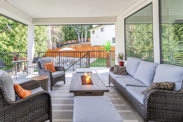 A spacious deck with a fire pit table heater