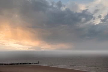 Fototapete The posts on the beach at Cadzand - The Netherlands. North sea landscape at sundown. Netherlands © britaseifert