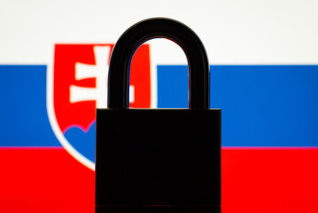 Conceptual photo of closed lock and flag of Slovakia. Sanctions, restrictions, closed border of Slovakia concept