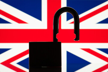 Flag of Great Britain behind open lock silhouette. Concept of freedom, end of restrictions, bans, open Great Britain