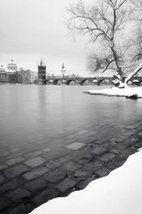 Charles Bridge in Prague in the morning in winter. Europe cities. Black and White. Prague. Snow. Long exposure.
