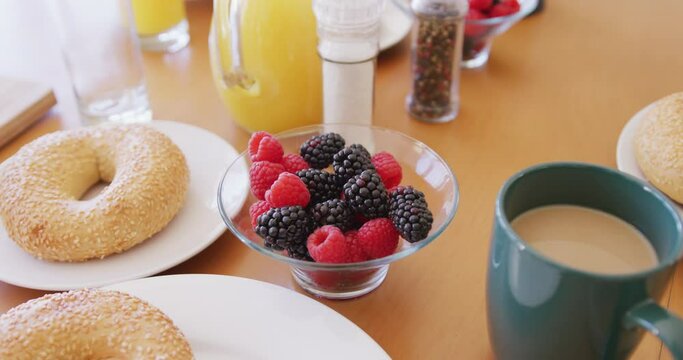 Close up of fresh bread and fruit on breakfast with coffee and orange juice on table