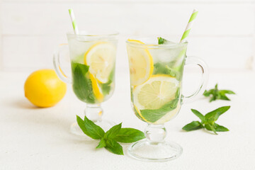 Mojito cocktail. Refreshing mojito cocktail with lime, lemon and mint in a tall glass with a stick