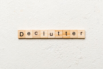 Declutter word written on wood block. Declutter text on cement table for your desing, concept
