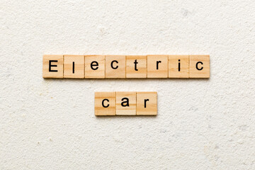 Electric Car word written on wood block. Electric Car text on cement table for your desing, concept