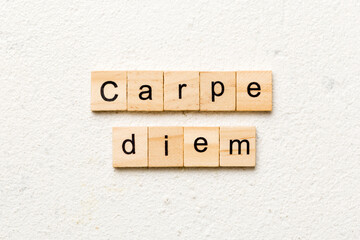 Carpe diem word written on wood block. Carpe diem text on table, concept