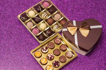 Box with delicious chocolate candies and heart shape gift