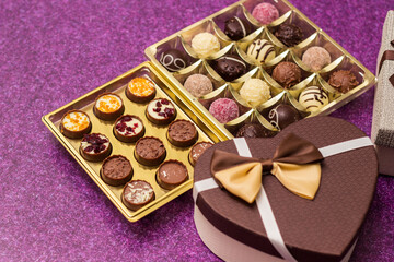 Box with delicious chocolate candies and heart shape gift