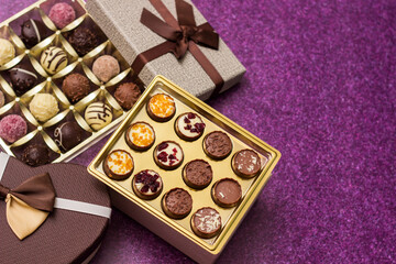 Box with delicious chocolate candies and heart shape gift