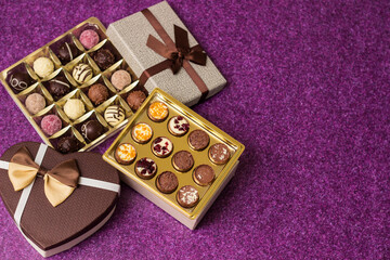 Box with delicious chocolate candies and heart shape gift