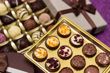 Box with delicious chocolate candies and heart shape gift