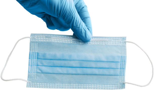 The hand holds a medical and protective mask Concept of coronavirus quarantine.