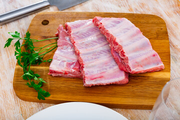 Raw pork ribs ready for cooking on cutting board