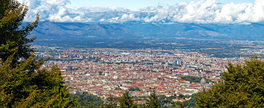 Aerial panorama of the historic center of Turin (Piedmont, Italy) seen from Colle della Maddalena with Alps on the background