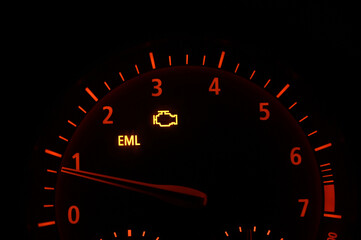 RPM gauge tachometer and moving pointer on dashboard in the car. Check engine light on. 