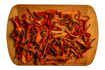 Background of dried organic red capsicum kappia sweet bell pepper chips, paprika and fresh pepper slices. The concept of healthy eating.
