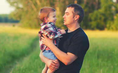 Father and son having fun in the nature on sunny spring day