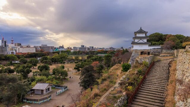Storm clouds move over Akashi Castle Park before sunset
