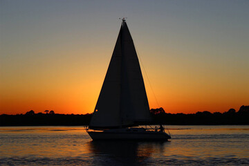 Obraz na płótnie Canvas Sailboat at sunset in a Florida inlet. 
