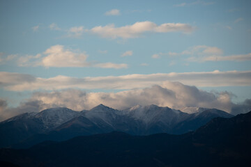 Fototapeta na wymiar Clouds over the snowy mountains 4