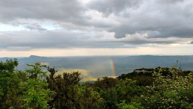 Cloudy sunset with a rainbow view on the pic Saint Loup mountain near Montpellier
