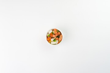 Delicious vinaigrette with tomato, onion, bell pepper on white background. Top view. Typical Brazilian food. Selective focus