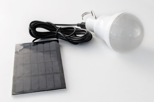 Autonomous rechargeable light bulb with solar panel, on a white background