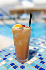 Frozen Margarita or Daiquiry Fresh cocktail drink at the poolside outdoors, nobody. Vacation, summer, holiday, luxury resort concept. Coral shade drink. Vertical