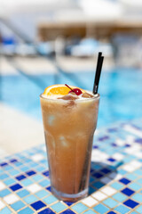 Frozen Margarita or Daiquiry Fresh cocktail drink at the poolside outdoors, nobody. Vacation, summer, holiday, luxury resort concept. Coral shade drink. Vertical