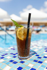 Frozen Margarita or Daiquiry Fresh cocktail drink at the poolside outdoors, nobody. Vacation, summer, holiday, luxury resort concept. Coral shade drink. Vertical