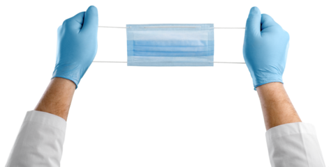 A medic's hand holding face mask over blue textured. Protective respiratory mask