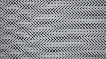gray background, in the photo a metal mesh chain link on a gray sky background close-up