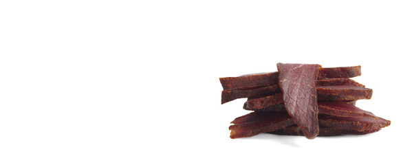 Pieces of delicious beef jerky on white background. Banner design