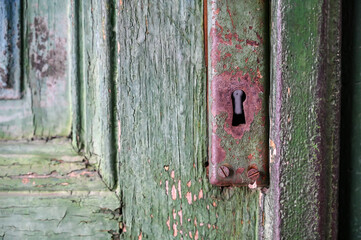 Keyhole on the old door lock. Old wooden door from the house.