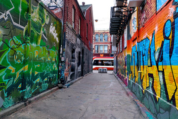 Toronto graffiti alley - Abstract colourful graffiti paintings on concrete walls.  Street art, background, texture.