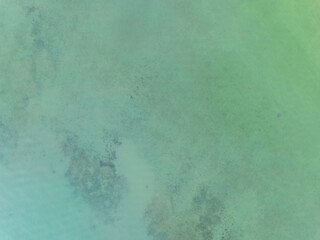 Top view of green sea surface, Shot in the open sea from above,Amazing nature background of Turquoise Water surface waves reflecting the Sunlight