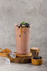 Boba or tapioca pearls is taiwan bubble milk tea in plastic cup with chocolate mint flavor on...