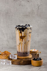 Boba or tapioca pearls is taiwan bubble milk tea in plastic cup with coffee latte flavor on texture...